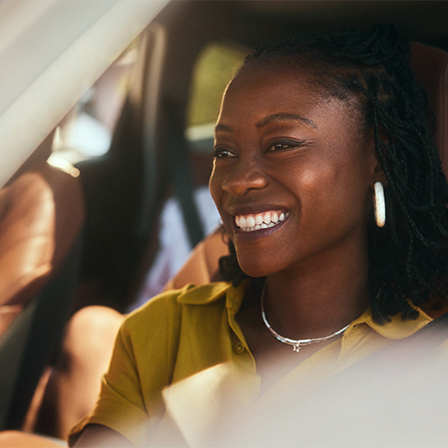 close up of woman smiling inside a vehicle